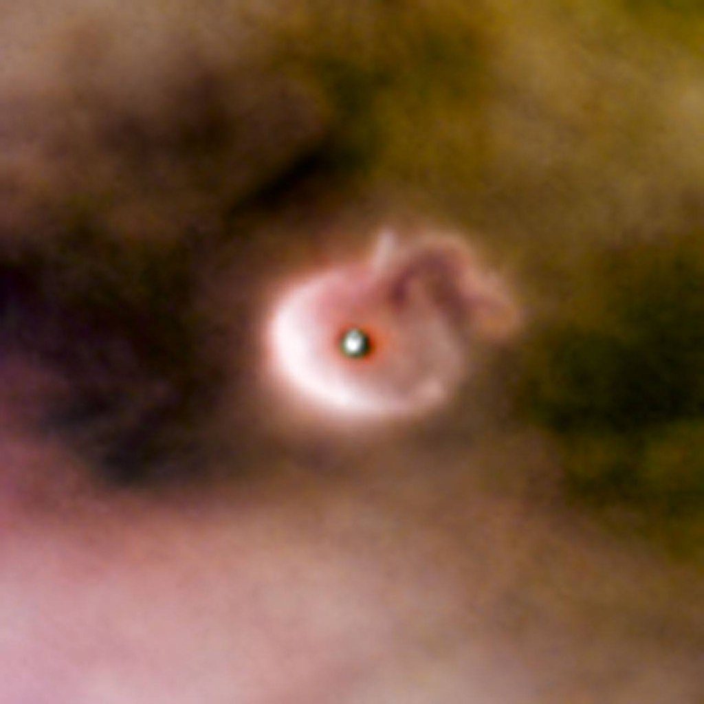 Disque protoplanétaire entourant un jeune système solaire dans la nébuleuse d'Orion.
