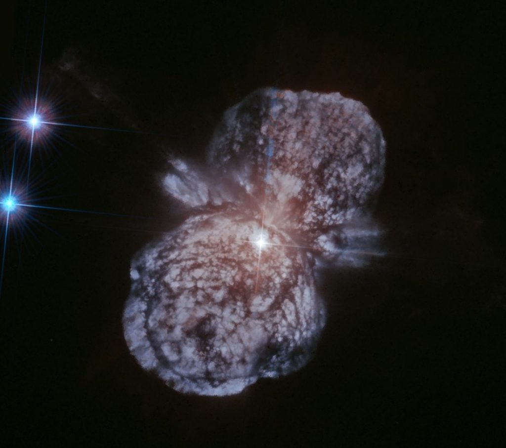 L'étoile Eta Kila est le point blanc au centre de l'image, à la jonction des deux lobes de la nébuleuse de l'Homonculus.